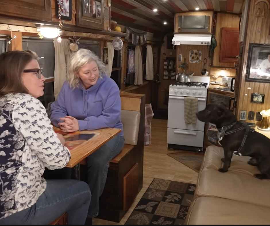 The couples, sitting in their dining area by the living room with the kitchen at the back