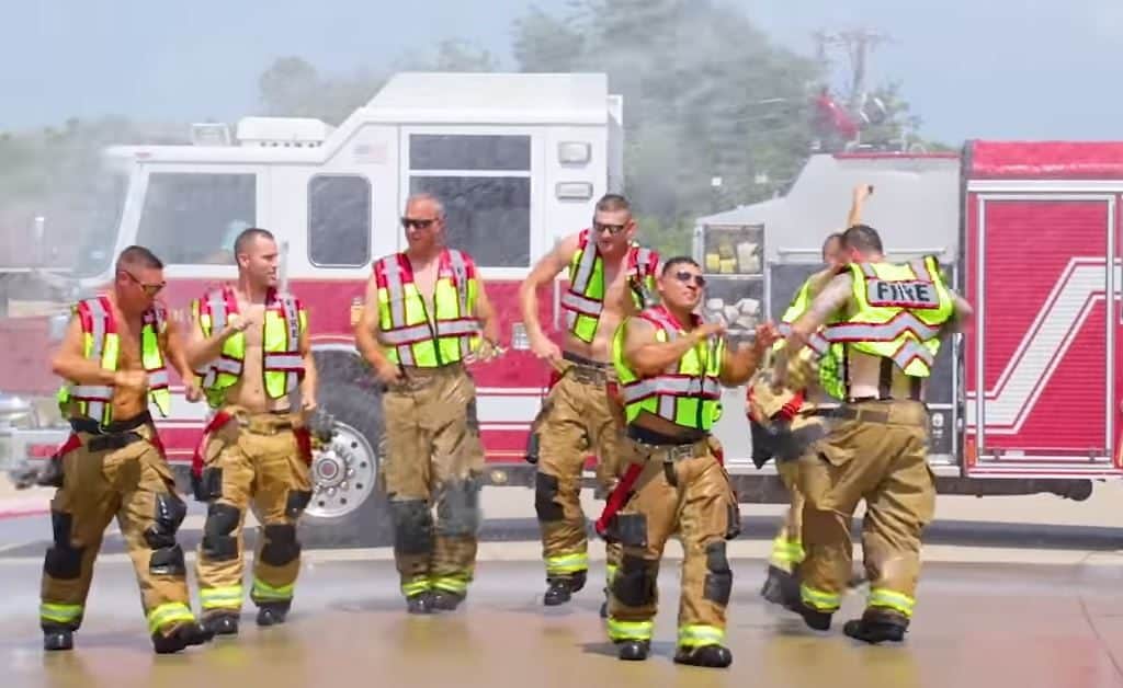 Firemen dancing in front of their firetruck for the lip-sync challenge.