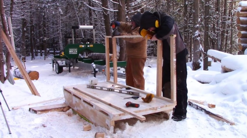 father and son building snowmobile camper
