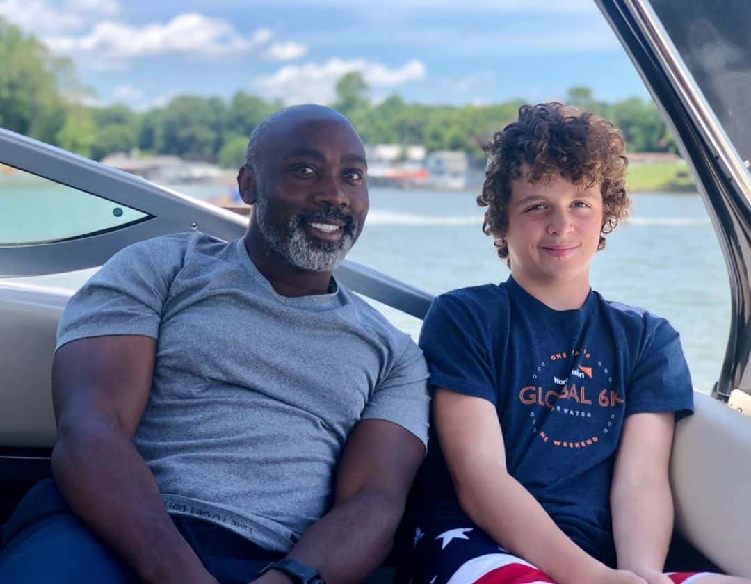 Peter and his adopted son in a boat relaxing