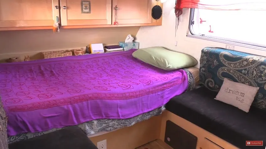 The colorful bed in her tiny home.