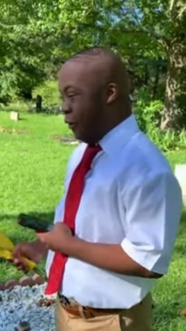 Son honors mom in the cemetery on day of graduation.