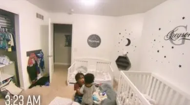 Young boy trying to get his little brother to go back to sleep