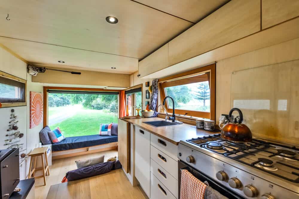 The kitchen and living room of a tiny house truck