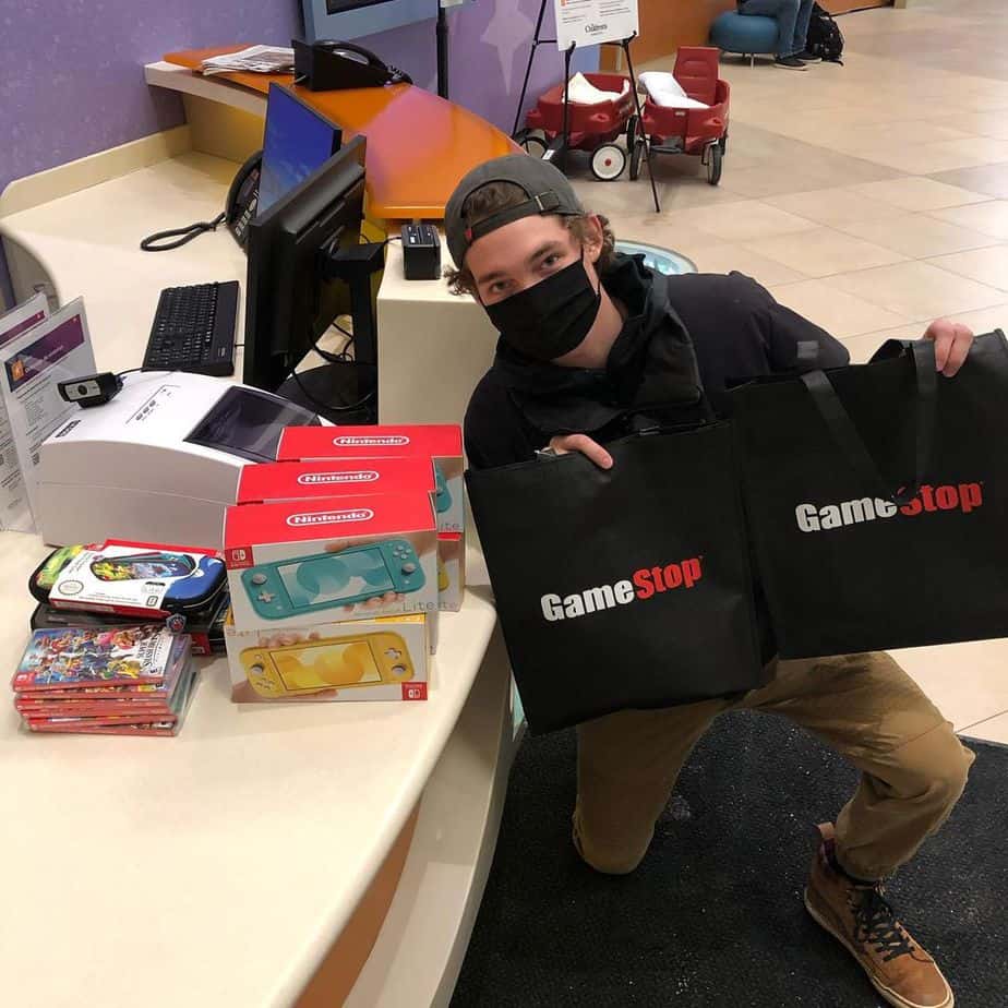 Hunter Kahn with the GameStop merchandise he will donate to Children's Minnesota hospital 