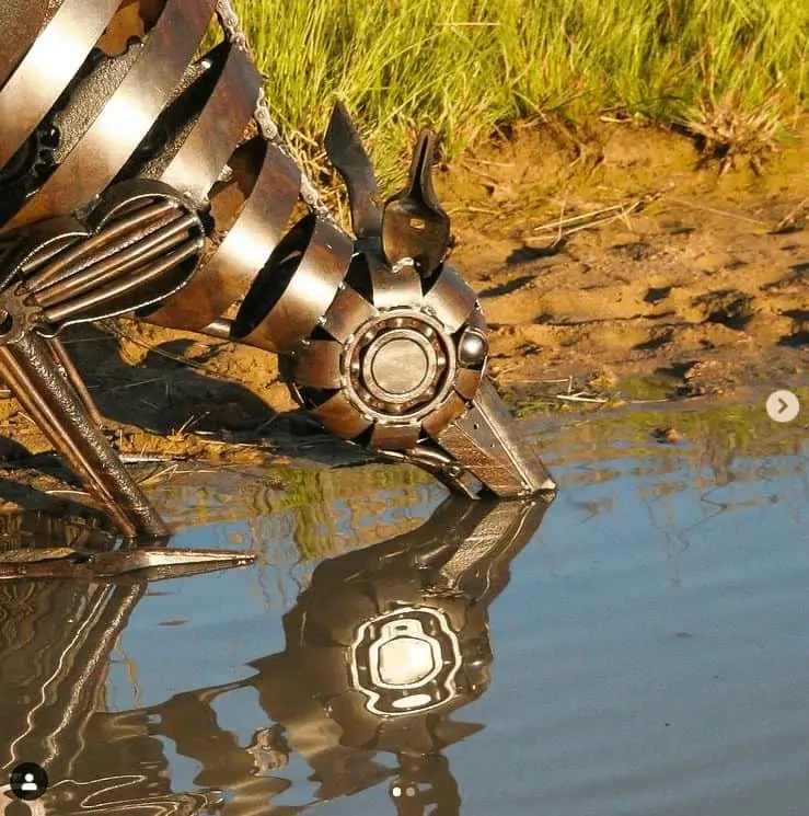 A life-like metal sculpture, quenching his thirst for water