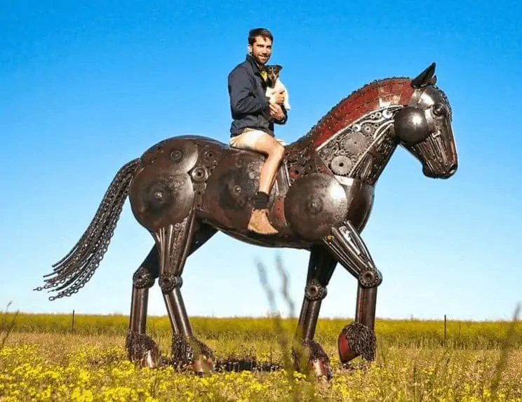 Jordan Sprigg, riding a metal sculpture of a stallion he made. 
