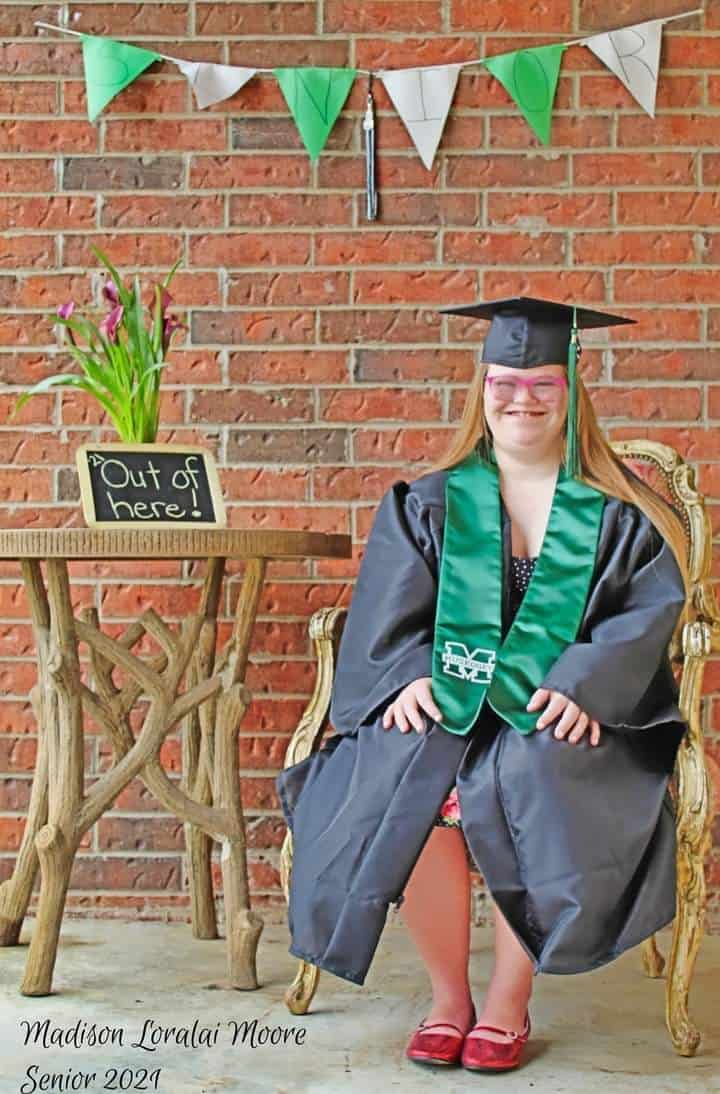 Madison Moore wearing her cap and gown during her graduation