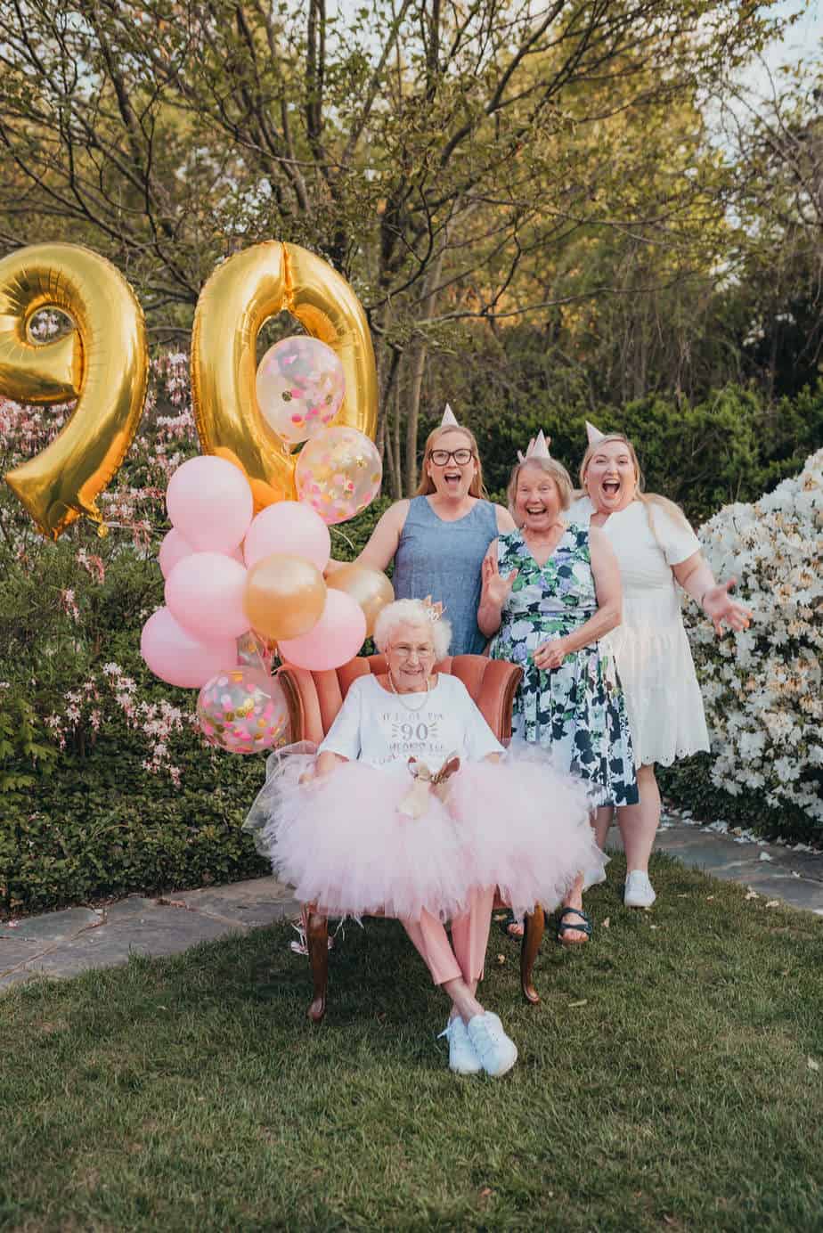 A grandma with her daugther and two grandaughters during her 90th birthday