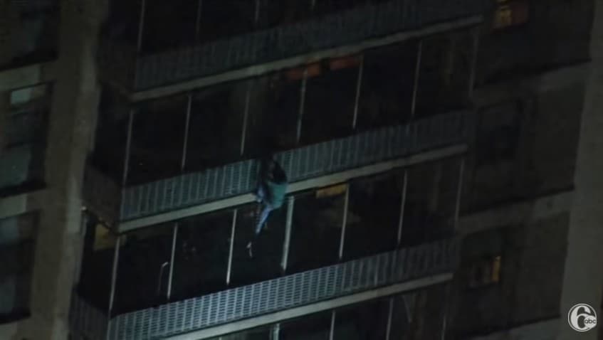 Jermaine climbing down an apartment building