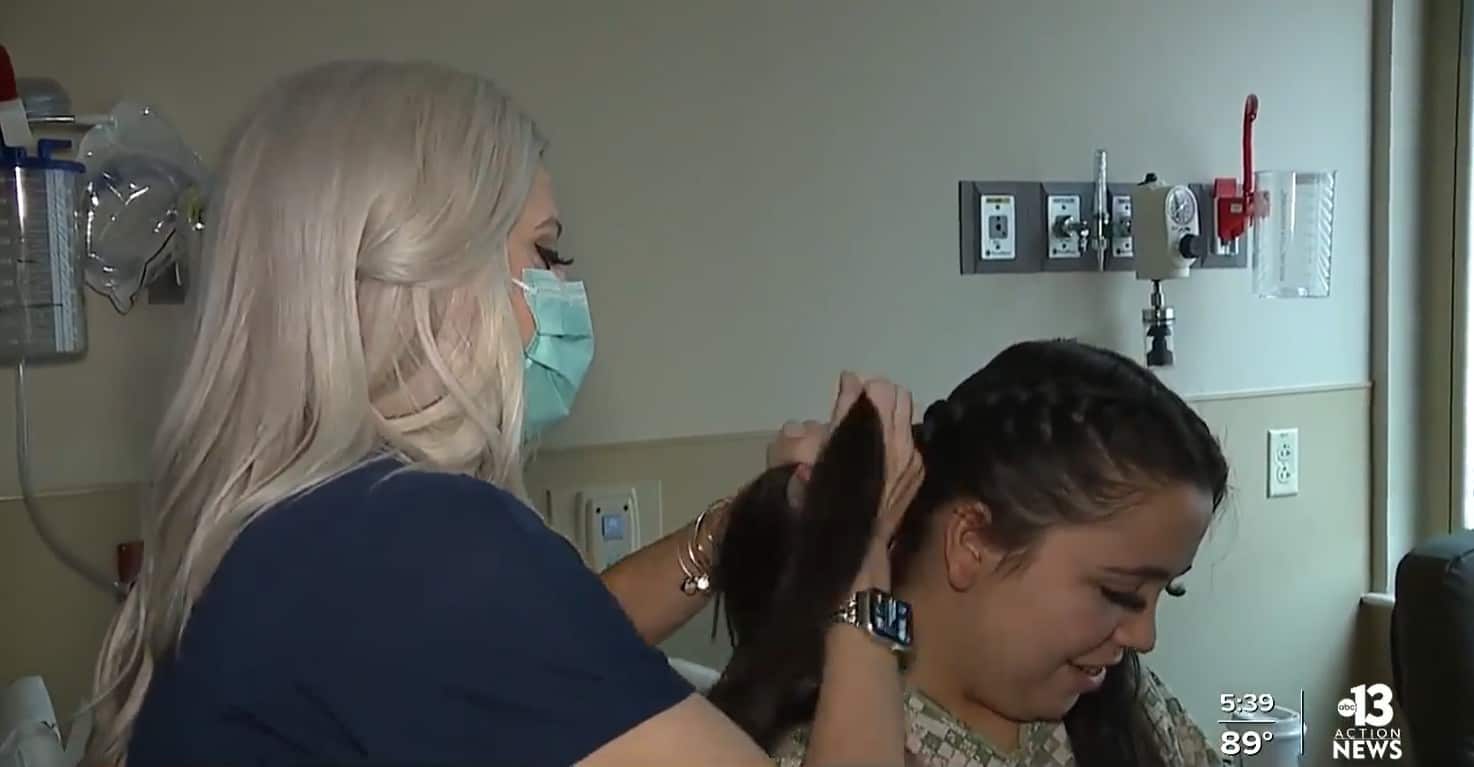 Nurse Brooke Johns braiding a patient's hair