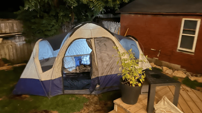 A tent sent up in a backyard