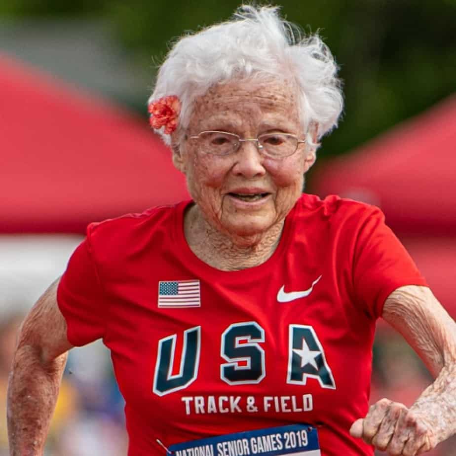 Julia Hawkins running the 100-meter dash during the 2021 Louisiana Senior Games with a red flower tucked behind her right ear
