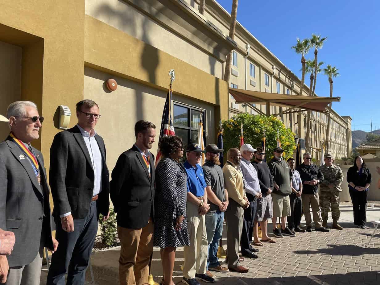 U.S. VETS members and elected officials standing in front of the hotel turned into a housing facility for veterans in Phoenix