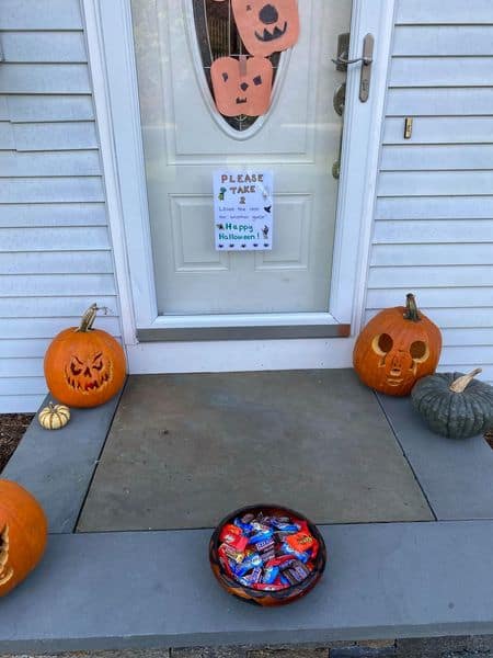 A porch with a bowl of treats for Halloween
