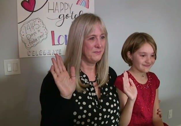 Zoe Henry and Loralie Henry raising their right hands during the virtual adoption ceremony