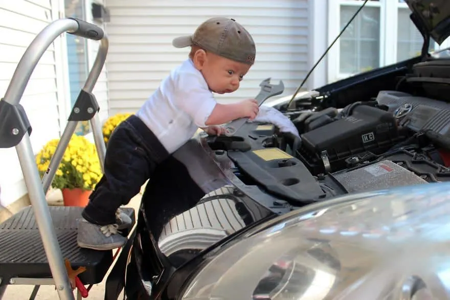 A Photoshopped picture of baby Ryan fixing a car