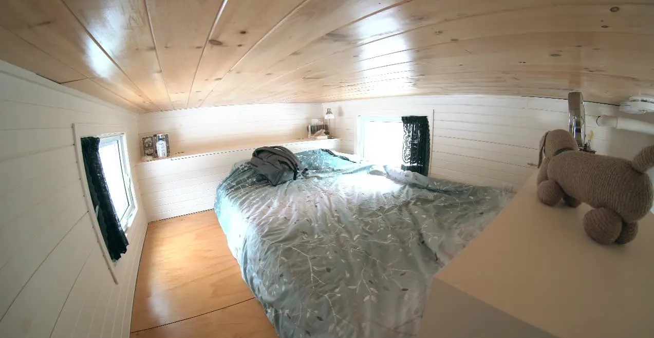 The loft area bedroom inside a tiny trailer home