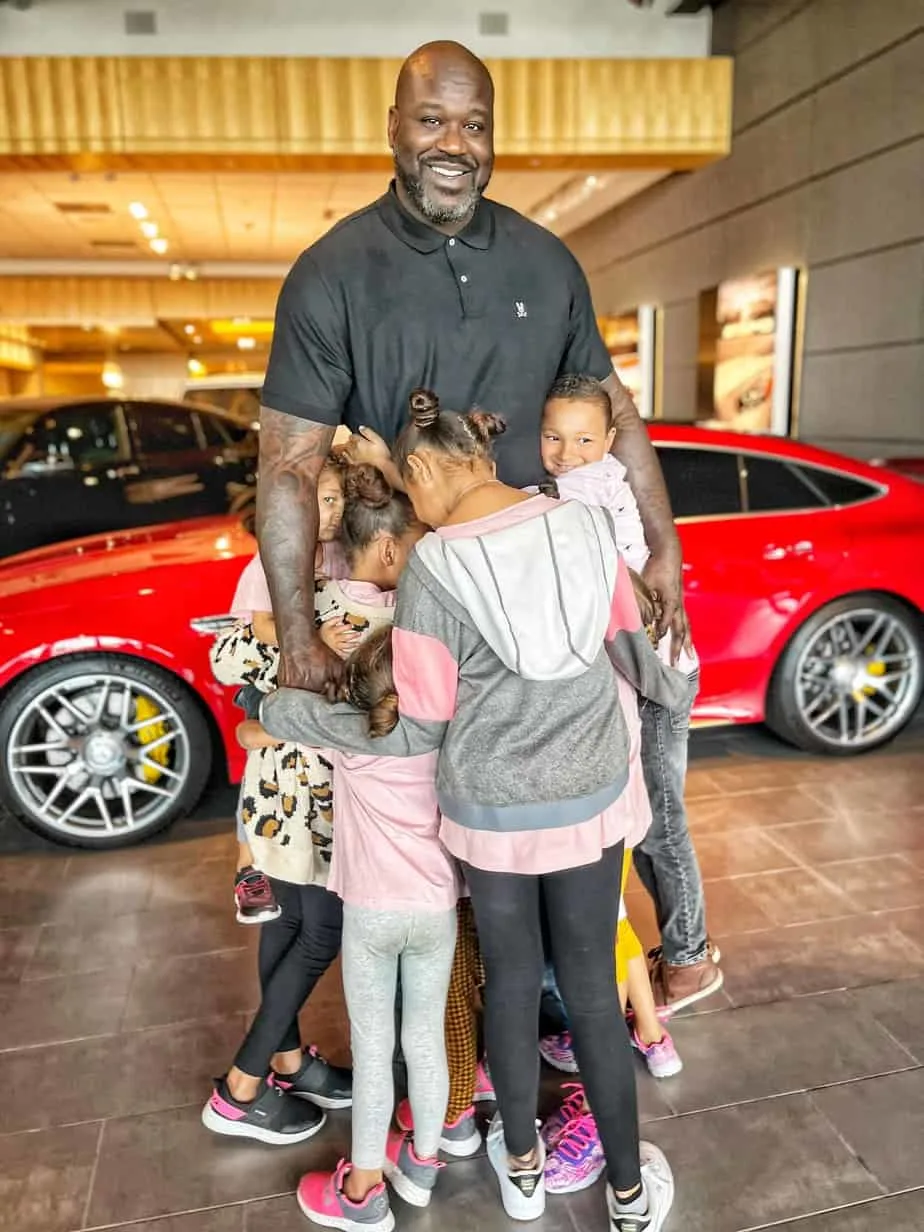 Shaquille O'Neal with the Collins kids inside a car dealership