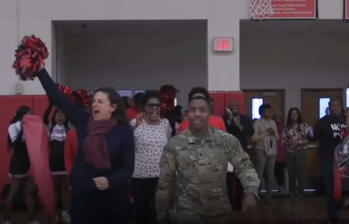 U.S. Army Spc. Shakir Aquil walking into the Therrell High School basketball court