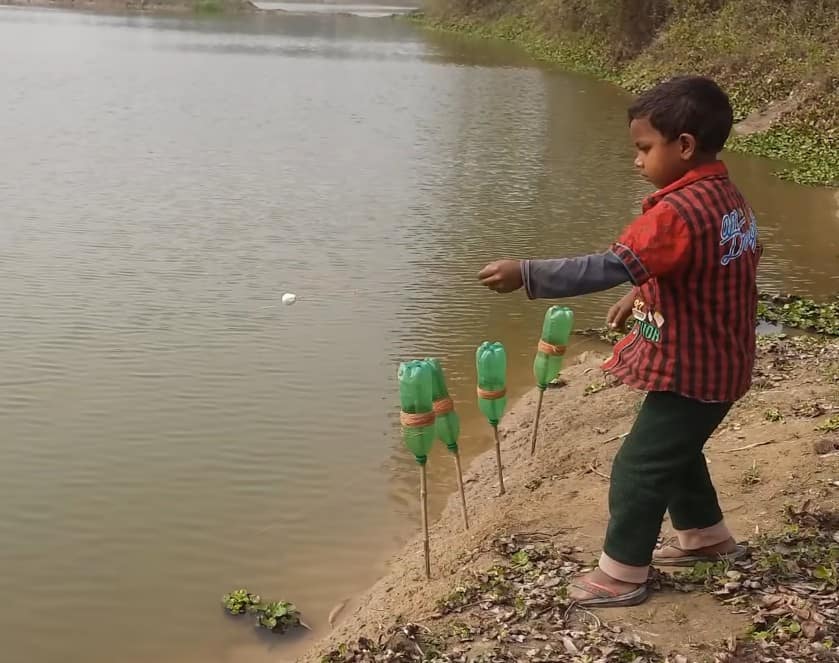 A young boy throwing fishing lines into the water