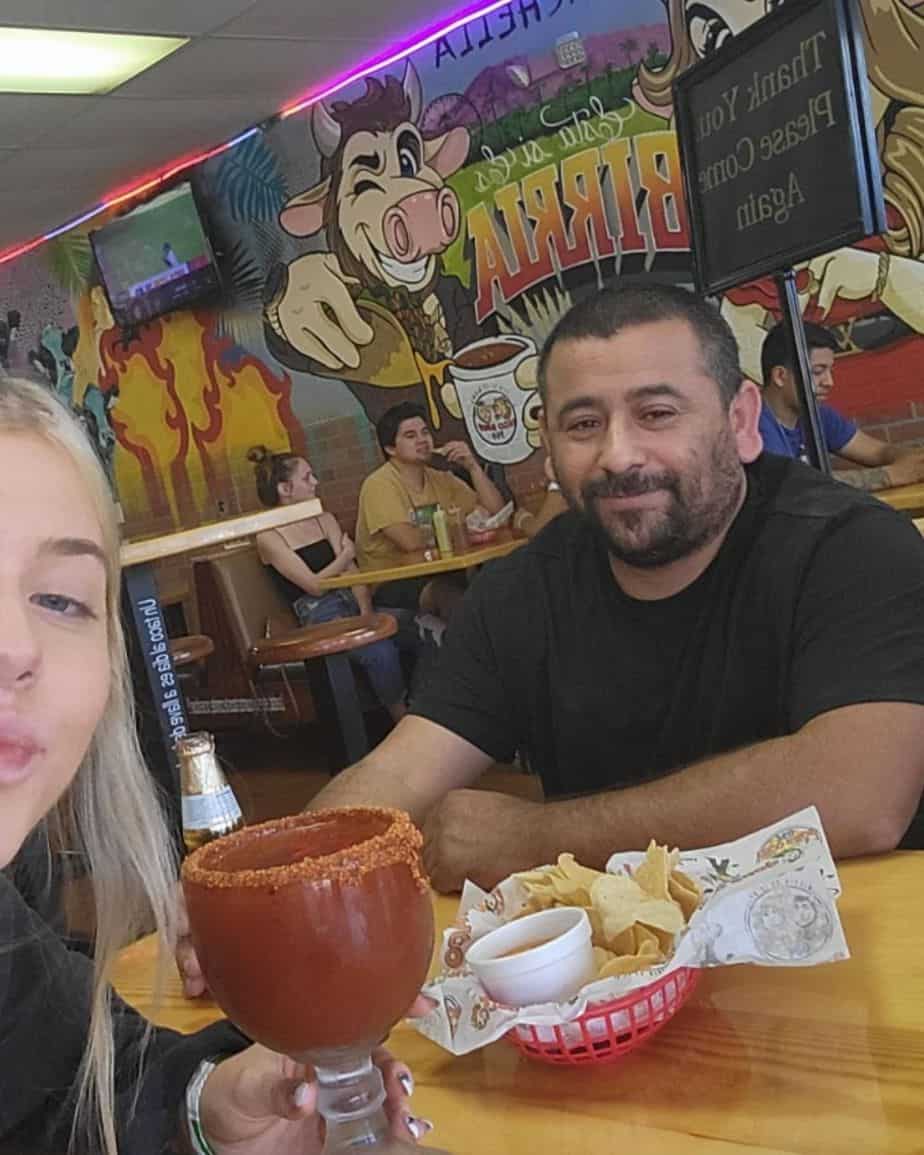 Becca Moore and Raul Torres having margaritas in a restaurant