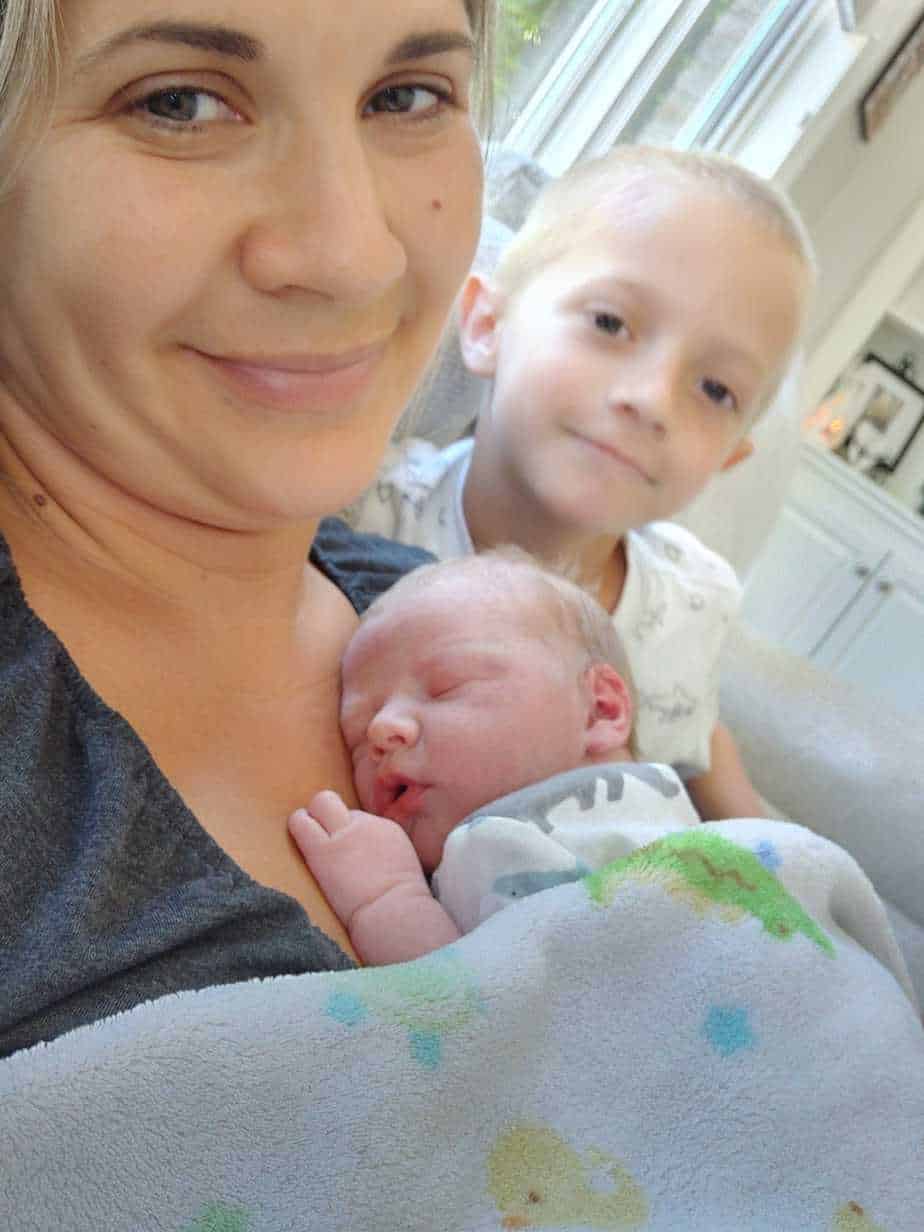 Heather Skaats' newborn baby sleeping on her chest as her other son looks on