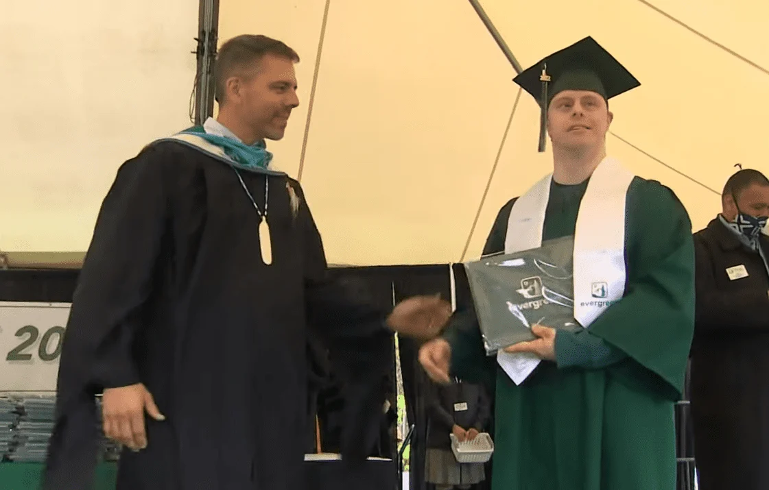 Dylan Keuhl receiving his diploma
