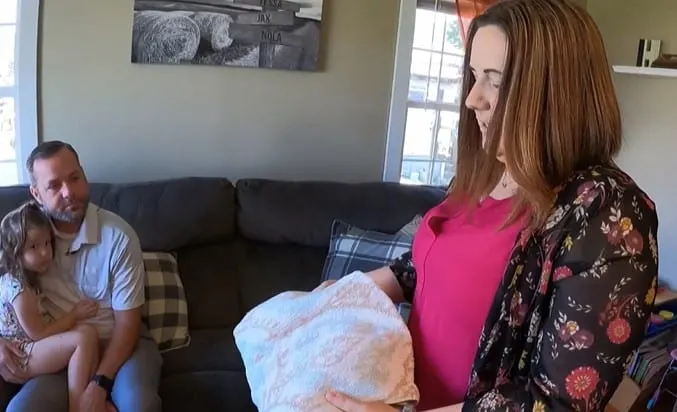 Tessa Higgs holding the towel wrapped around baby Nola when she was surrendered