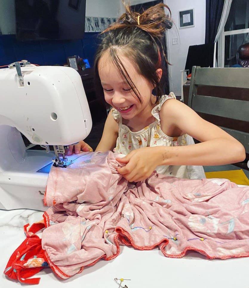 Kaia Aragon at work sewing one of her designs