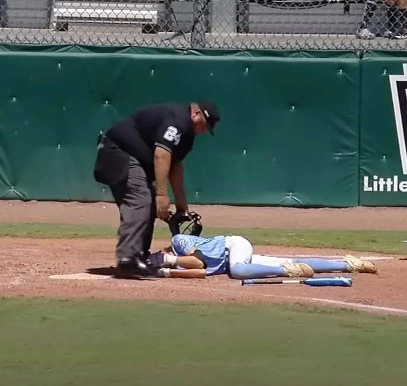 Baseball umpire comforts injured player