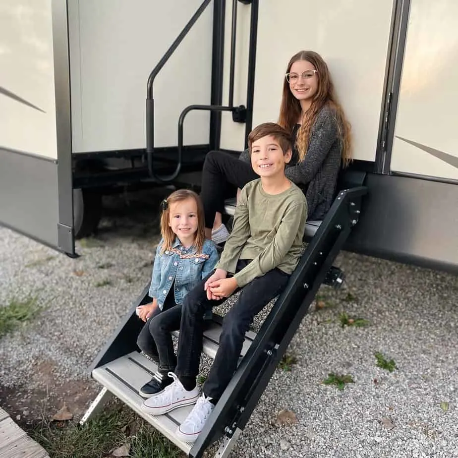 he Garcia children are all smiles on the steps of their RV as they enjoy full time RV living.