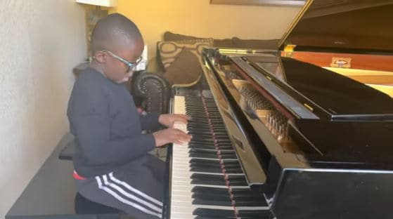 Jude playing the grand piano