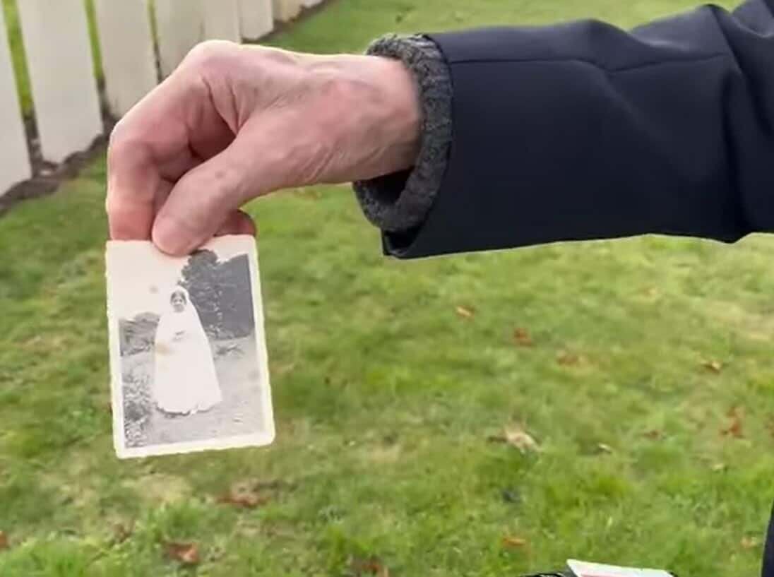 The elderly veteran holding a photo