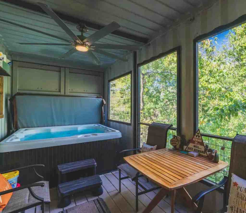 The Air Castle's hot tub area with screened windows to enjoy the nature.