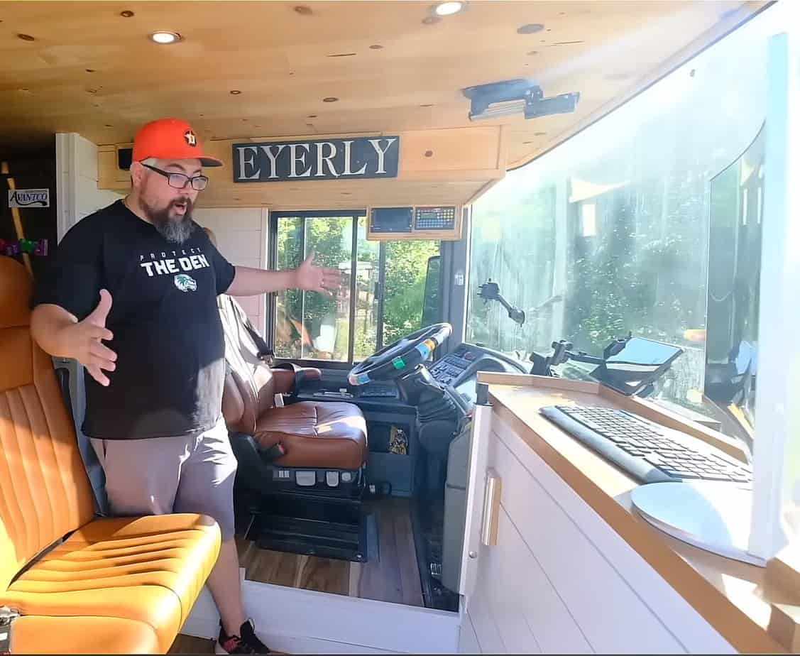 Dane showing his cockpit and office in his double decker bus