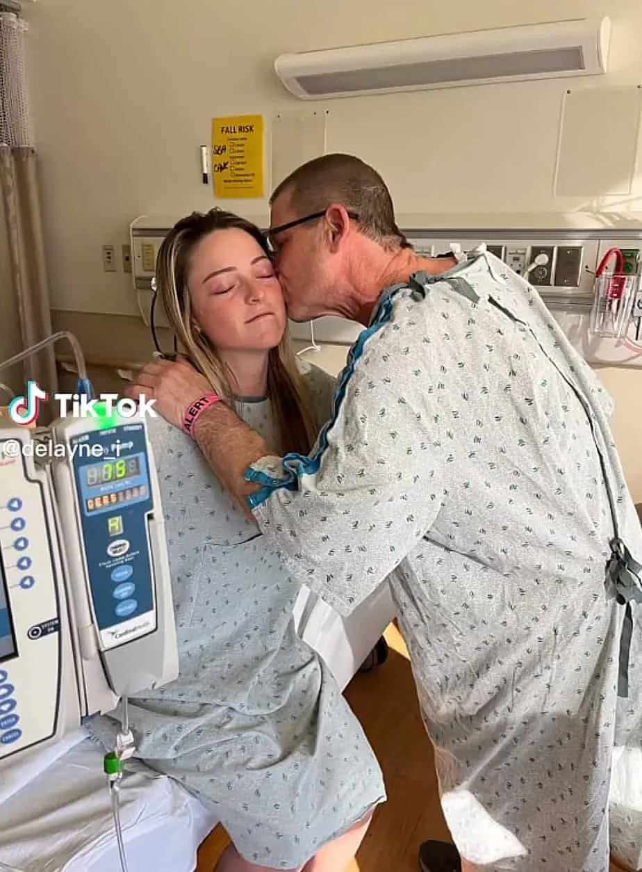 John kisses his daughter as she thanked her for her life-saving surprise.