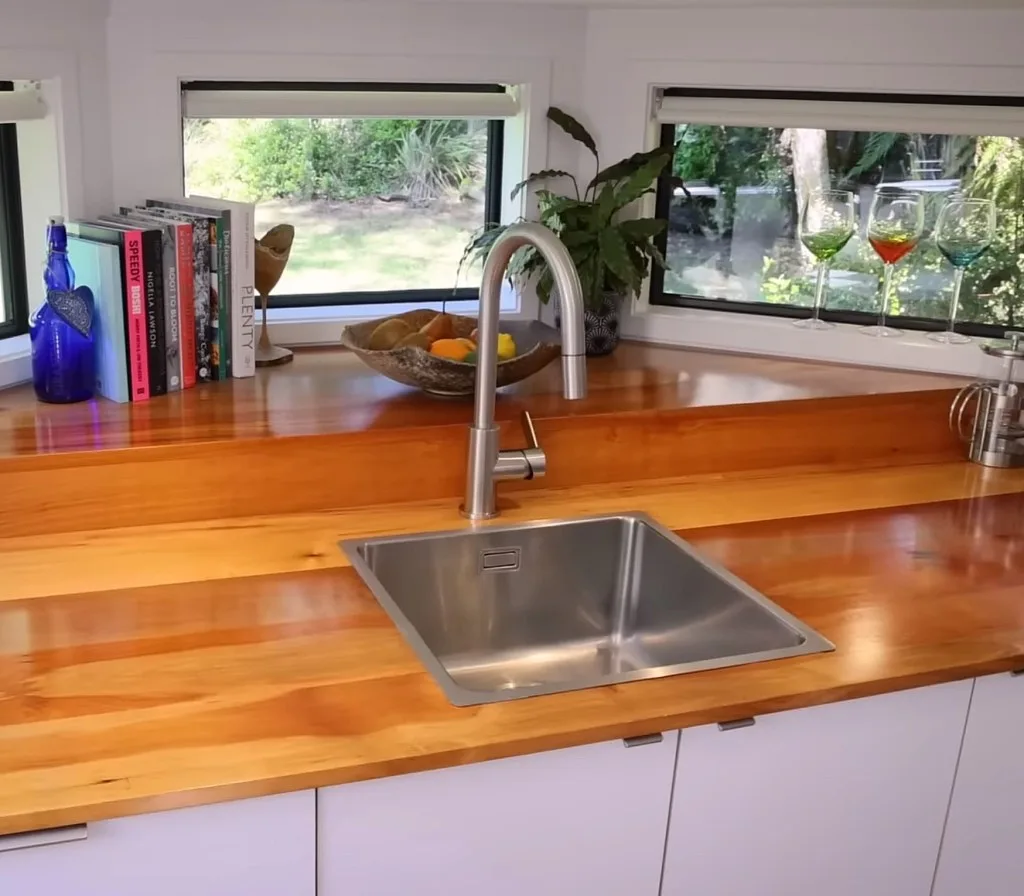 Forest tiny house's kitchen sink and wooden counter top.
