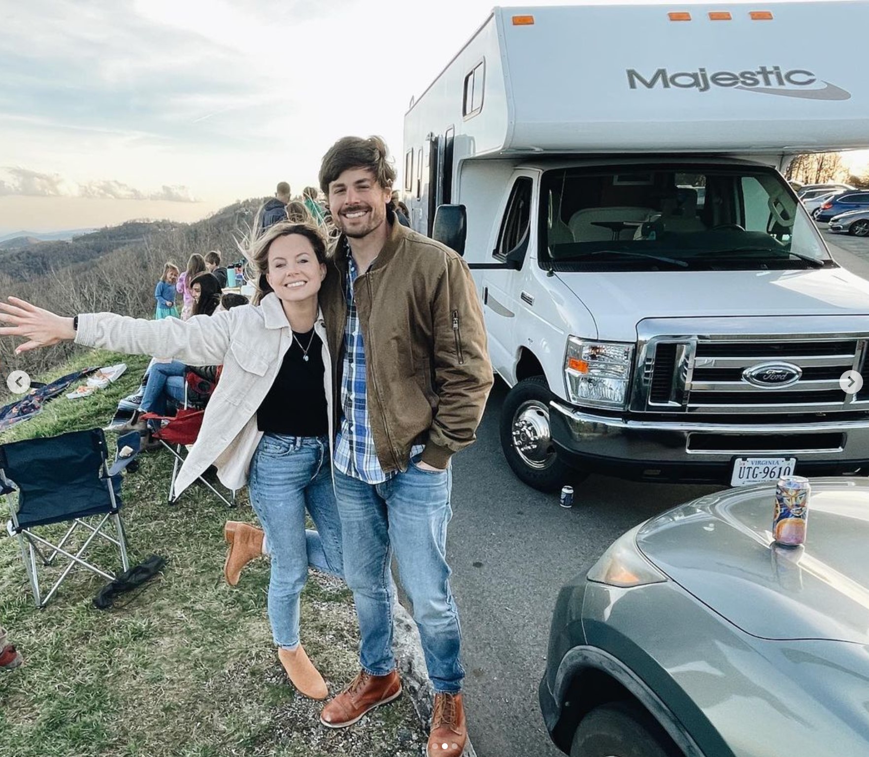 Erin and Jon standing in front of their RV.