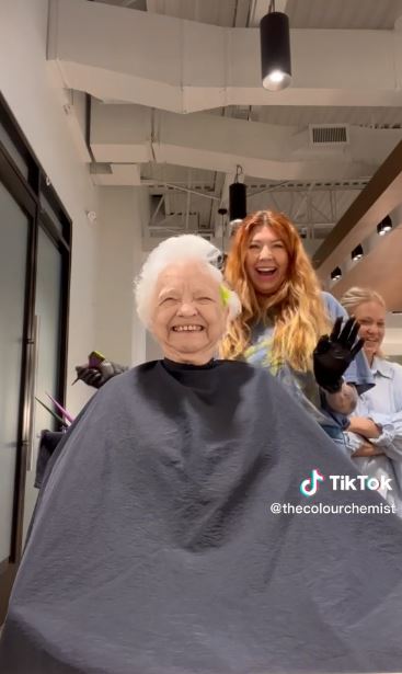 Grandma is all smiles while granddaughter does hair coloring