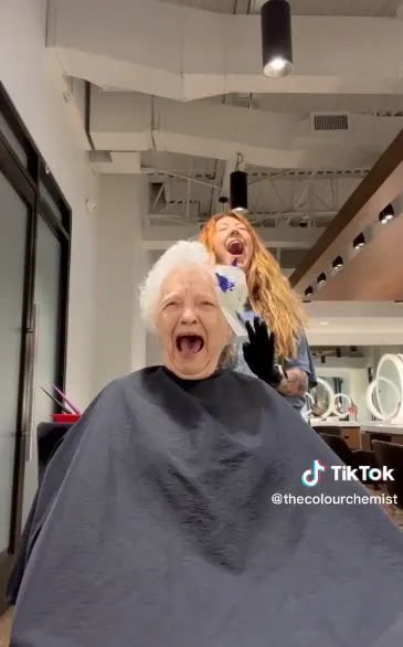 Grandma laughs while hair coloring.