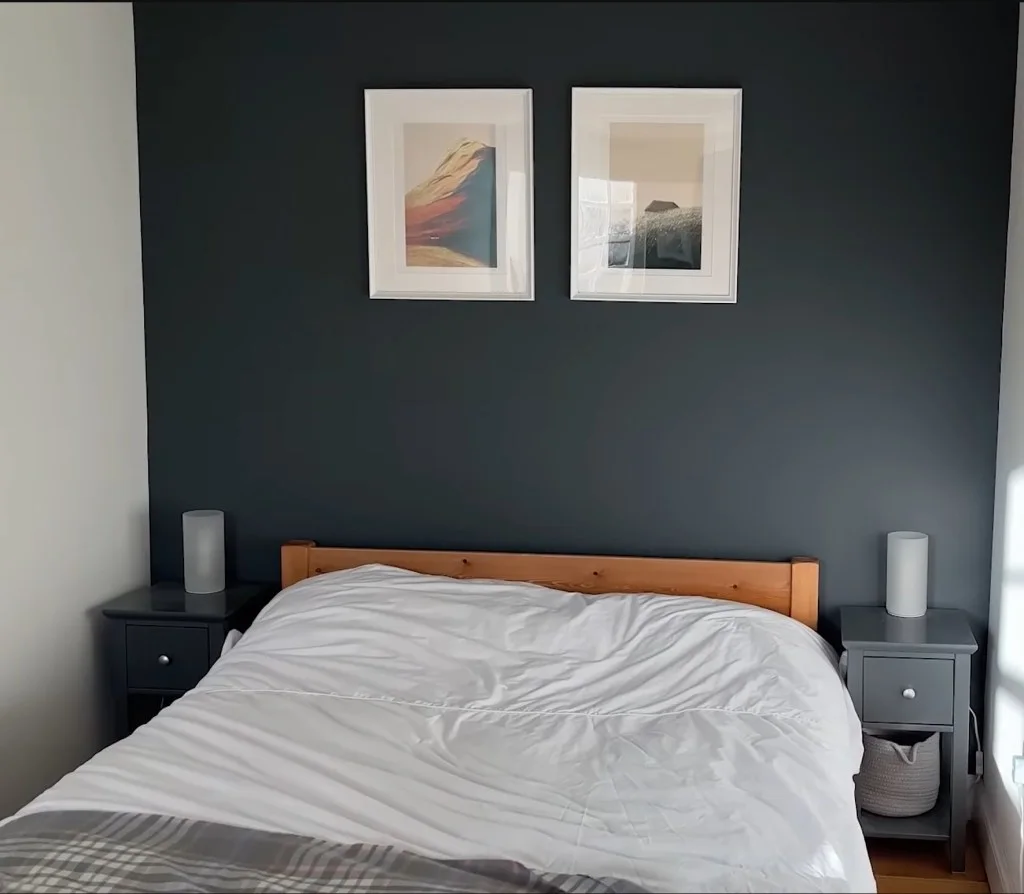 George's minimalist bedroom with low-down bed and tables on each side.