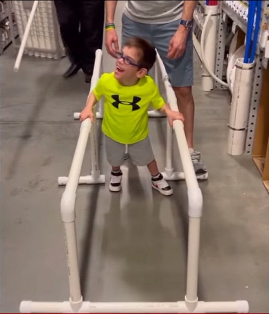 William testing the parallel bars at the hardware store.