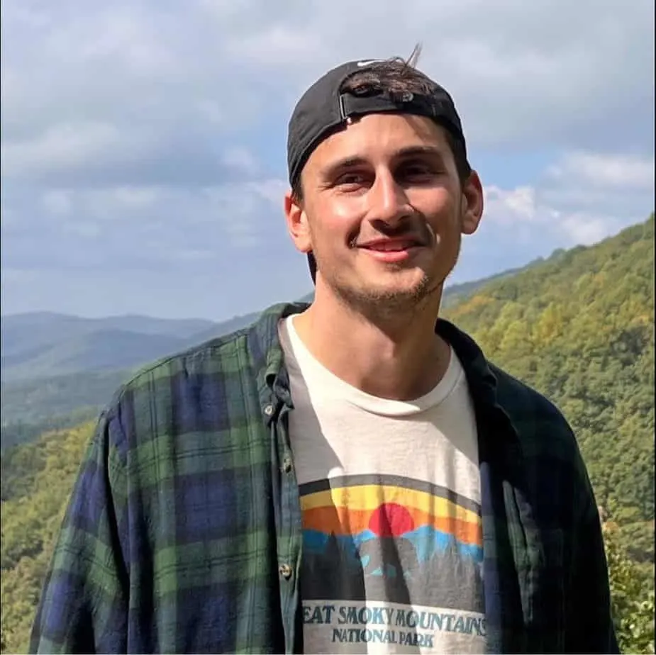 Zach Cross looks happy after a mountain hike.