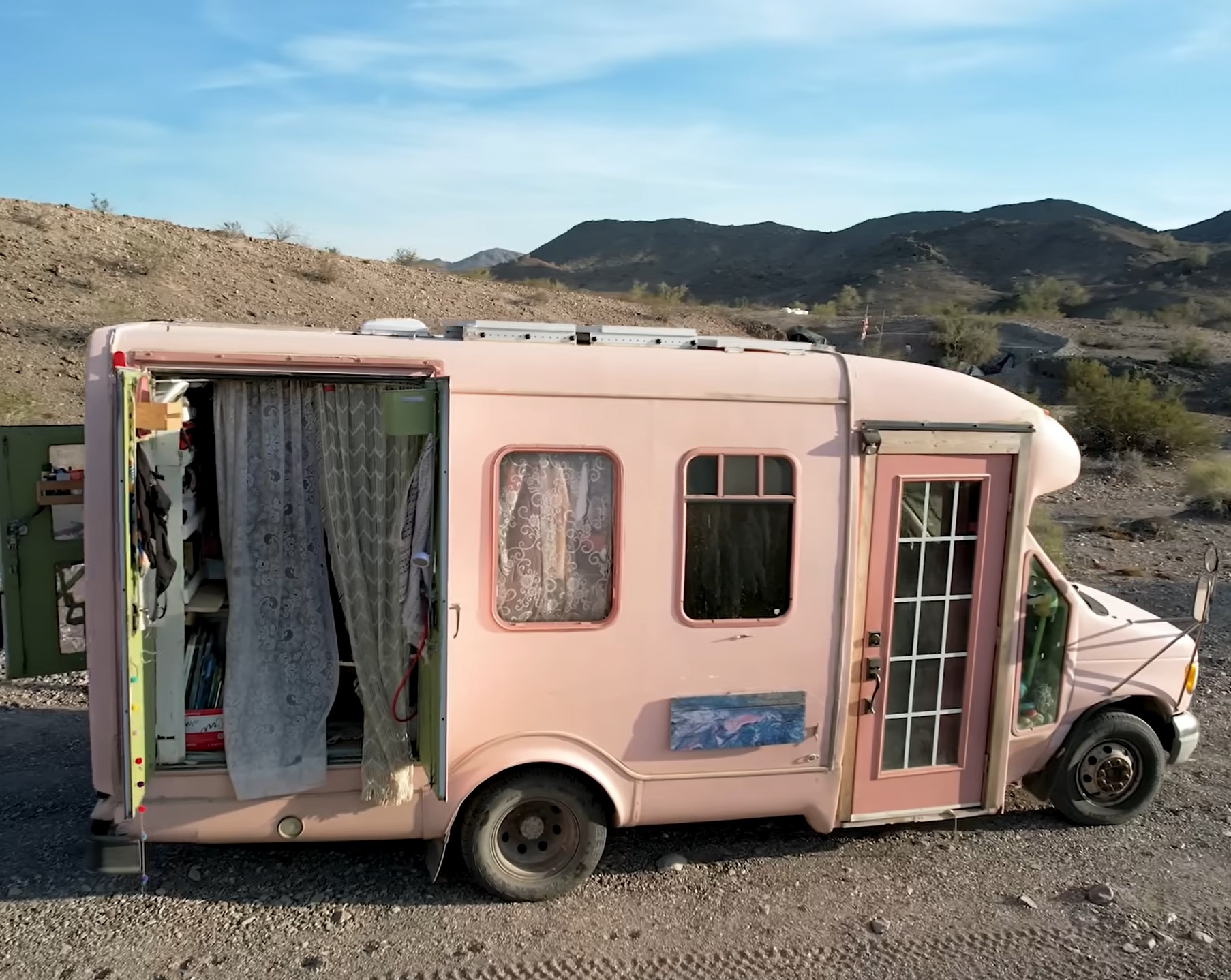 Outside view of Wilbur, Rita's pink bus tiny home.
