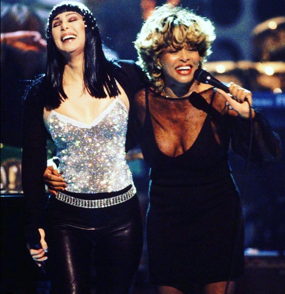 Tina Turner and Cher laughing togehter after a performance.