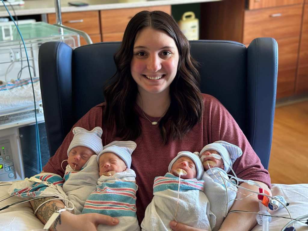 Hannah holding her 2 sets of identical twins