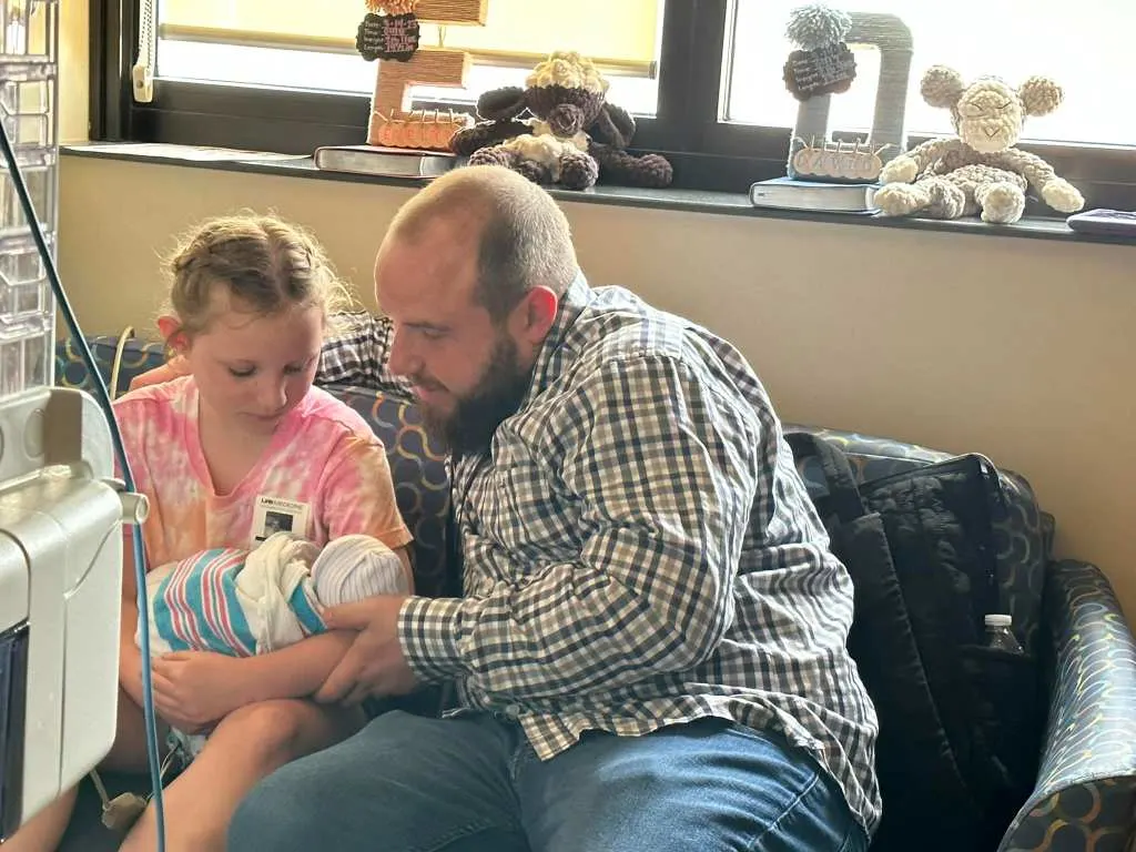 Michael and daughter Emily look after one of the quadruplets