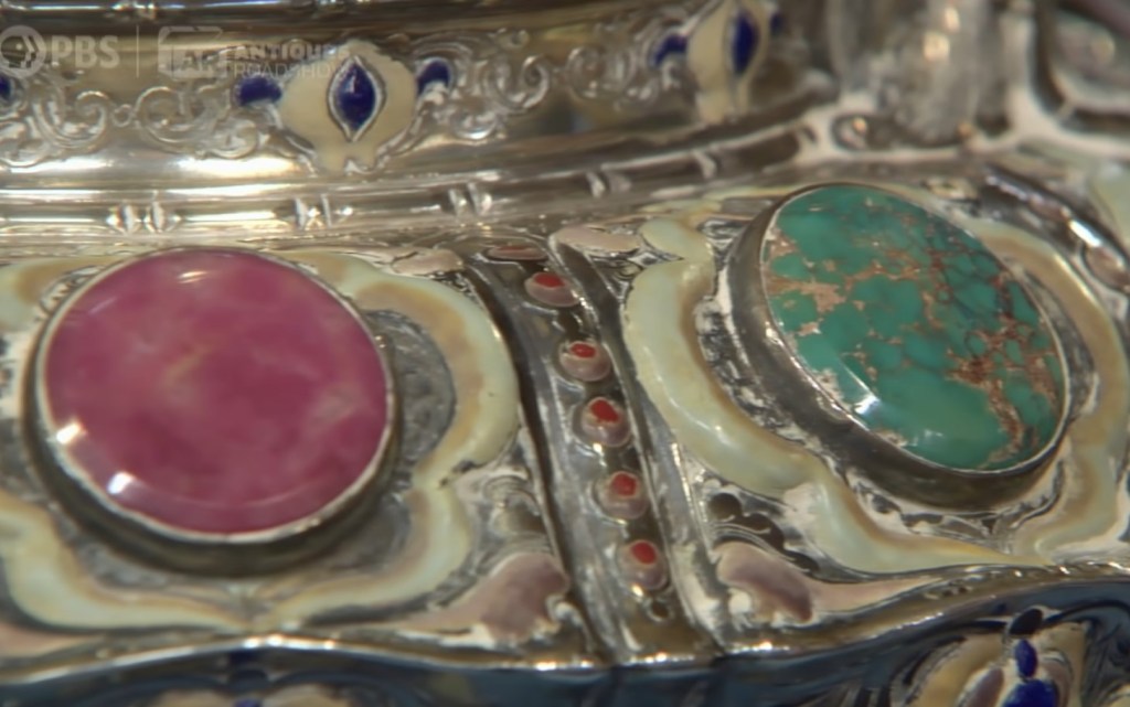 The Tiffany Vase has turquoise stones decorating it.