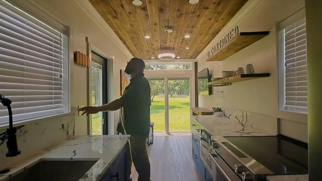 Micah Woods showing his house with custom container home interior design.